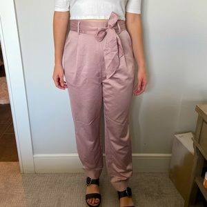 Pink satiny pants with bow tie belt